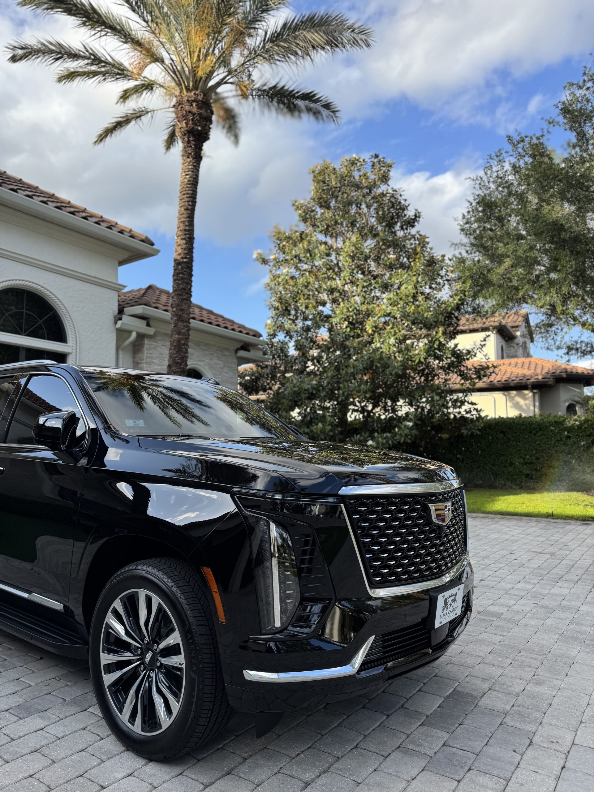 Black Cadillac Escalade at a luxury Orlando resort at sunset — Black Chariot Limousine