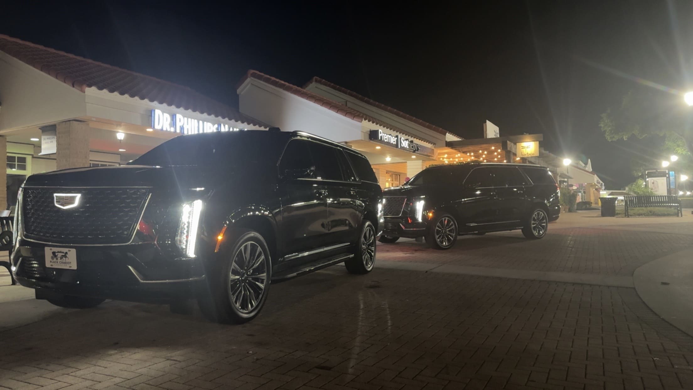 Black Cadillac Escalade at a luxury Orlando resort at sunset — Black Chariot Limousine service areas